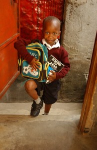 NAIROBI, KENYA, OCTOBER 17, 2003: Grace Twilimuli gets ready for work with her son Mandela in Nairobi, Kenya October 17, 2003. (Phot by Ami Vitale)