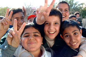 Iraqi boys giving peace sign by Christiaan Briggs